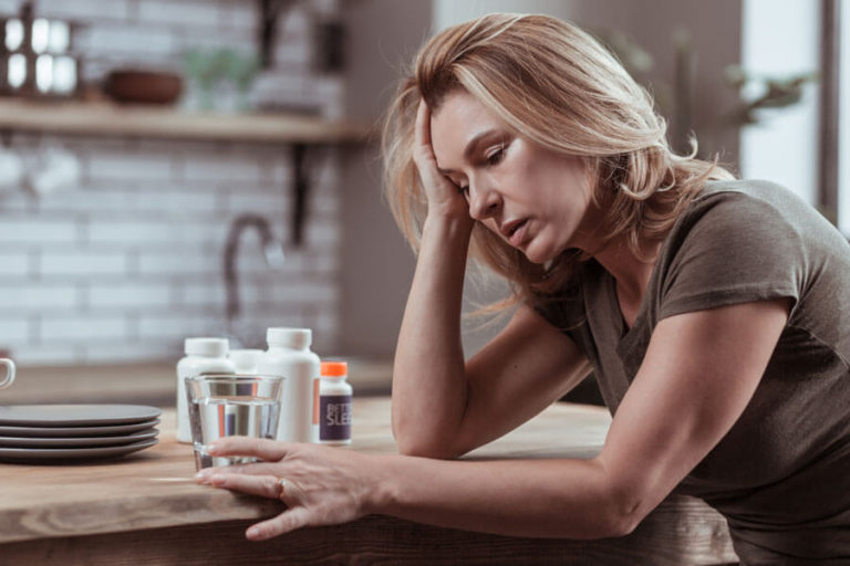 woman with prescription drug bottles